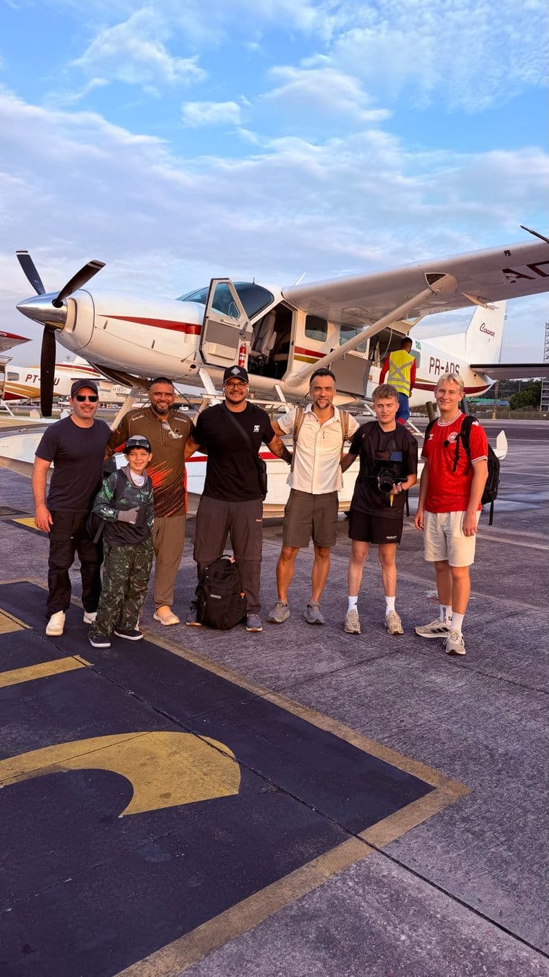 Anglers posing in front of the aircraft