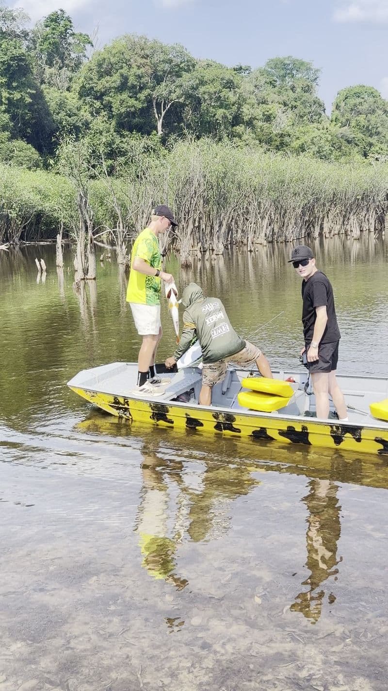 Anglers on a boat in shallow water